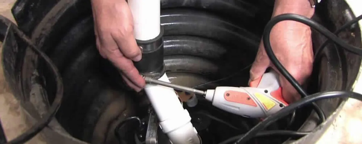 Sump pump installation technician connecting PVC discharge piping in Orlando, FL